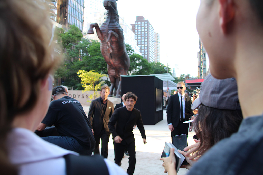 Tom Holland running to fans to sign autographs