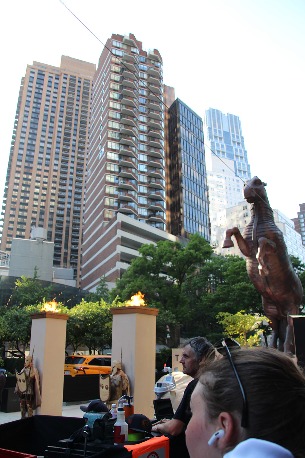 Fiery torch columns, soldiers, and Trojan Horse with Upper West Side backdrop